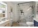 Bright bathroom showcasing a glass enclosed shower with white marble surround and a large window at 94 Glenn Se St, Atlanta, GA 30312