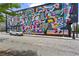 Building exterior showcasing a vibrant and colorful mural with a car parked nearby at 94 Glenn Se St, Atlanta, GA 30312
