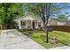 Charming home with a well-manicured lawn, front porch, and a paved driveway at 94 Glenn Se St, Atlanta, GA 30312