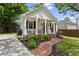 Charming home boasting a brick pathway, front porch seating, and a well-manicured lawn at 94 Glenn Se St, Atlanta, GA 30312
