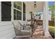 Covered front porch featuring a seating area with stylish wicker chairs and a view of the landscaped yard at 94 Glenn Se St, Atlanta, GA 30312