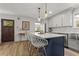 Bright kitchen with an island, stainless steel appliances, countertops, and white cabinets at 94 Glenn Se St, Atlanta, GA 30312