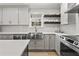 Bright kitchen features stainless steel appliances, white cabinetry, quartz countertops, and a modern faucet at 94 Glenn Se St, Atlanta, GA 30312