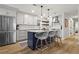 Bright kitchen features stainless steel appliances, white cabinetry, quartz countertops, and a navy blue kitchen island at 94 Glenn Se St, Atlanta, GA 30312