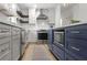 Bright kitchen with an island, stainless steel appliances, countertops, and navy and white cabinets at 94 Glenn Se St, Atlanta, GA 30312