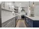 Bright kitchen with an island, stainless steel appliances, countertops, and white and navy cabinets at 94 Glenn Se St, Atlanta, GA 30312