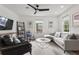 Inviting living room showcasing a comfortable seating arrangement, hardwood floors, and a contemporary ceiling fan at 94 Glenn Se St, Atlanta, GA 30312