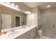 Bright bathroom featuring double sinks, a large mirror, and a frameless glass shower at 10143 Windalier Way, Roswell, GA 30076