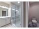 Modern bathroom with glass shower, white vanity, and a separate toilet area at 10143 Windalier Way, Roswell, GA 30076