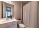Cozy bathroom with a white vanity, toilet, and shower featuring a shower curtain at 10143 Windalier Way, Roswell, GA 30076