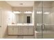 Elegant bathroom with double vanity, large mirror, and glass-enclosed shower with bench at 10143 Windalier Way, Roswell, GA 30076