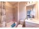 Bathroom featuring tub/shower combination, gray tile and white vanity at 10143 Windalier Way, Roswell, GA 30076