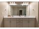 Well-lit bathroom with double sinks, a large mirror, and ample cabinet space at 10143 Windalier Way, Roswell, GA 30076