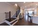 Grand entryway with staircase leading to the kitchen and living spaces, featuring hardwood floors at 10143 Windalier Way, Roswell, GA 30076