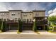 View of townhomes with rear garages and balconies at 10143 Windalier Way, Roswell, GA 30076