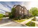 Beautiful brick townhome with manicured landscaping and charming front entrance at 10143 Windalier Way, Roswell, GA 30076