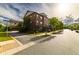 Beautiful brick townhome with manicured landscaping and charming front entrance at 10143 Windalier Way, Roswell, GA 30076