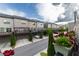 Townhome community showcasing well-maintained exteriors, lush landscaping, and convenient garage parking at 10143 Windalier Way, Roswell, GA 30076