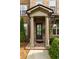 Elegant front entry featuring stately columns and lush landscaping at 10143 Windalier Way, Roswell, GA 30076
