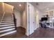 Hallway with hardwood floors leading to a staircase and an office area at 10143 Windalier Way, Roswell, GA 30076
