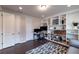 Bright home office featuring custom built-in shelving, modern desk, and dark wood flooring at 10143 Windalier Way, Roswell, GA 30076