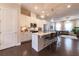 Open-concept kitchen with island seating, stainless steel appliances, and hardwood floors at 10143 Windalier Way, Roswell, GA 30076