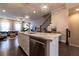 Kitchen island featuring barstool seating, modern pendant lighting, and stainless-steel appliances at 10143 Windalier Way, Roswell, GA 30076
