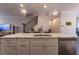 Kitchen island featuring white cabinets, stainless steel appliances, and a waterfall countertop at 10143 Windalier Way, Roswell, GA 30076