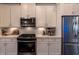 Well-equipped kitchen with white cabinets, stainless steel appliances, and subway tile backsplash at 10143 Windalier Way, Roswell, GA 30076