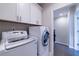 Laundry room features a front load washer and dryer, with lots of storage at 10143 Windalier Way, Roswell, GA 30076