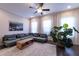 Bright living area features a large sectional sofa and a tall green plant at 10143 Windalier Way, Roswell, GA 30076
