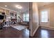 Cozy living room with custom built-ins, hardwood floors, and a sofa at 10143 Windalier Way, Roswell, GA 30076