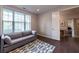 Comfortable living room with hardwood floors, a sofa, and ample natural light at 10143 Windalier Way, Roswell, GA 30076
