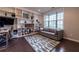 Bright living room with custom built-ins, hardwood floors, and stylish decor at 10143 Windalier Way, Roswell, GA 30076