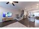 Inviting living room with a TV, staircase, and kitchen island at 10143 Windalier Way, Roswell, GA 30076