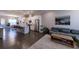 Open-concept living room flowing into a kitchen with an island and modern appliances at 10143 Windalier Way, Roswell, GA 30076