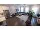 Spacious living room with high ceilings, hardwood floors, and large windows providing ample natural light at 10143 Windalier Way, Roswell, GA 30076