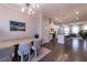 Bright, open-concept living space featuring a dining area, modern kitchen, and sleek hardwood floors at 10143 Windalier Way, Roswell, GA 30076