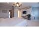 Stylish main bedroom has carpeted floors, wood accent wall, TV, and a fan at 10143 Windalier Way, Roswell, GA 30076