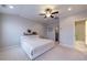 Relaxing primary bedroom with carpeted floors, a fan and an ensuite bathroom at 10143 Windalier Way, Roswell, GA 30076