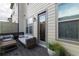 Inviting outdoor patio with cozy seating, a privacy wall, and views of the well-manicured backyard at 10143 Windalier Way, Roswell, GA 30076