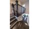 Elegant staircase featuring dark wood steps and railings, leading to a bright living area at 10143 Windalier Way, Roswell, GA 30076