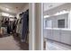 Organized walk-in closet with shelves and hanging rods, leading to a bathroom at 10143 Windalier Way, Roswell, GA 30076