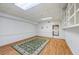 Spacious basement area with wood flooring, bright lighting, and adjacent kitchen access at 1402 Bromley Dr, Snellville, GA 30078