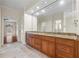 Bathroom featuring a double vanity with granite countertops, a large mirror, and recessed lighting at 1402 Bromley Dr, Snellville, GA 30078