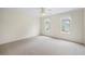 Bright bedroom features neutral carpet, ceiling fan, and well-lit windows with charming curtains at 1402 Bromley Dr, Snellville, GA 30078