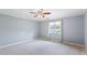 Bedroom with neutral carpet, blue walls, white trim, and natural light from a window at 1402 Bromley Dr, Snellville, GA 30078