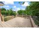 Well-maintained wooden deck overlooking a private backyard with mature trees and lush greenery at 1402 Bromley Dr, Snellville, GA 30078
