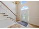Bright foyer showcasing a staircase, decorative rug, and elegant front door with sidelights at 1402 Bromley Dr, Snellville, GA 30078