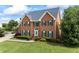A beautiful two-story brick home boasts lush landscaping and classic architectural design at 1402 Bromley Dr, Snellville, GA 30078